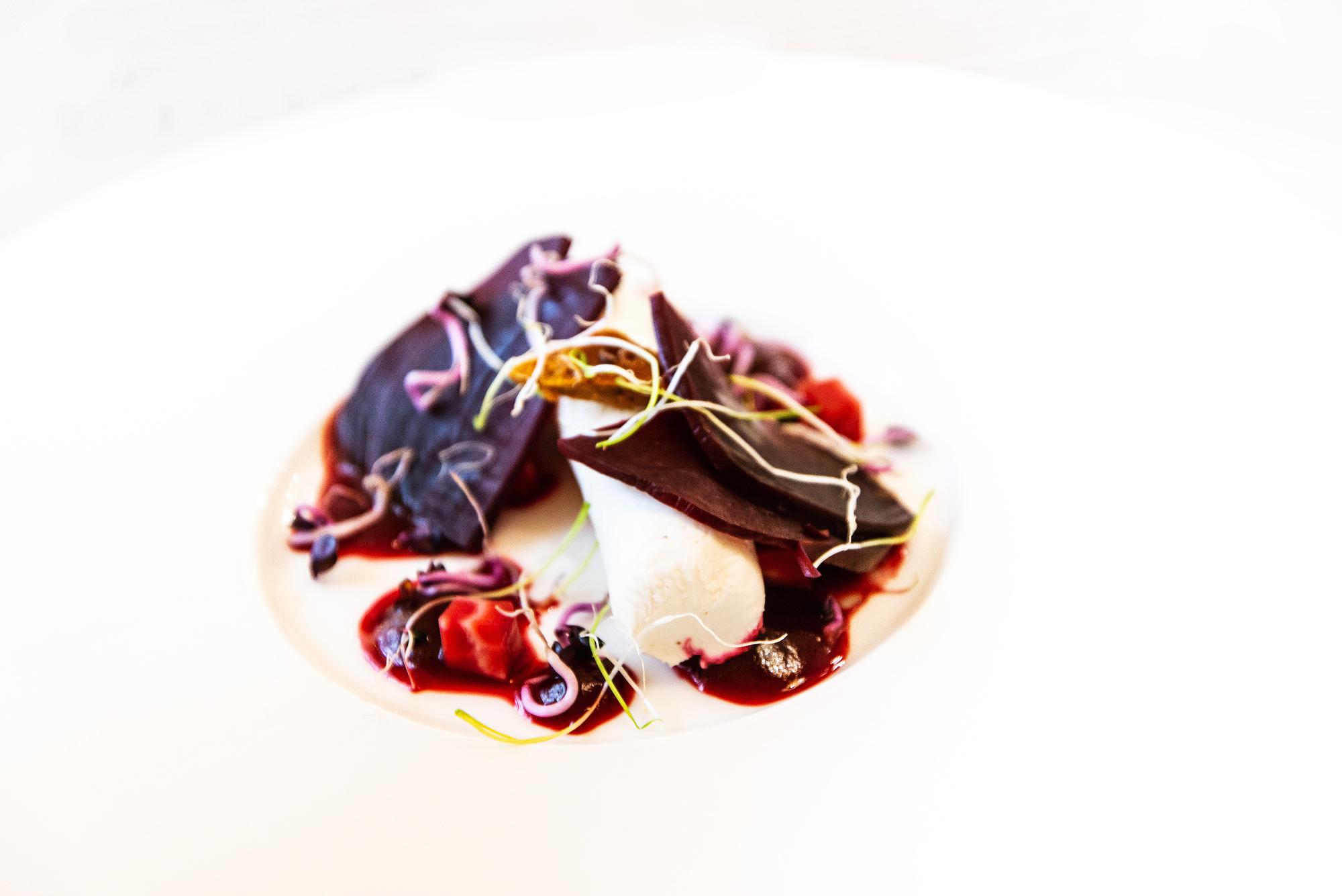Hands arranging plated dish in studio