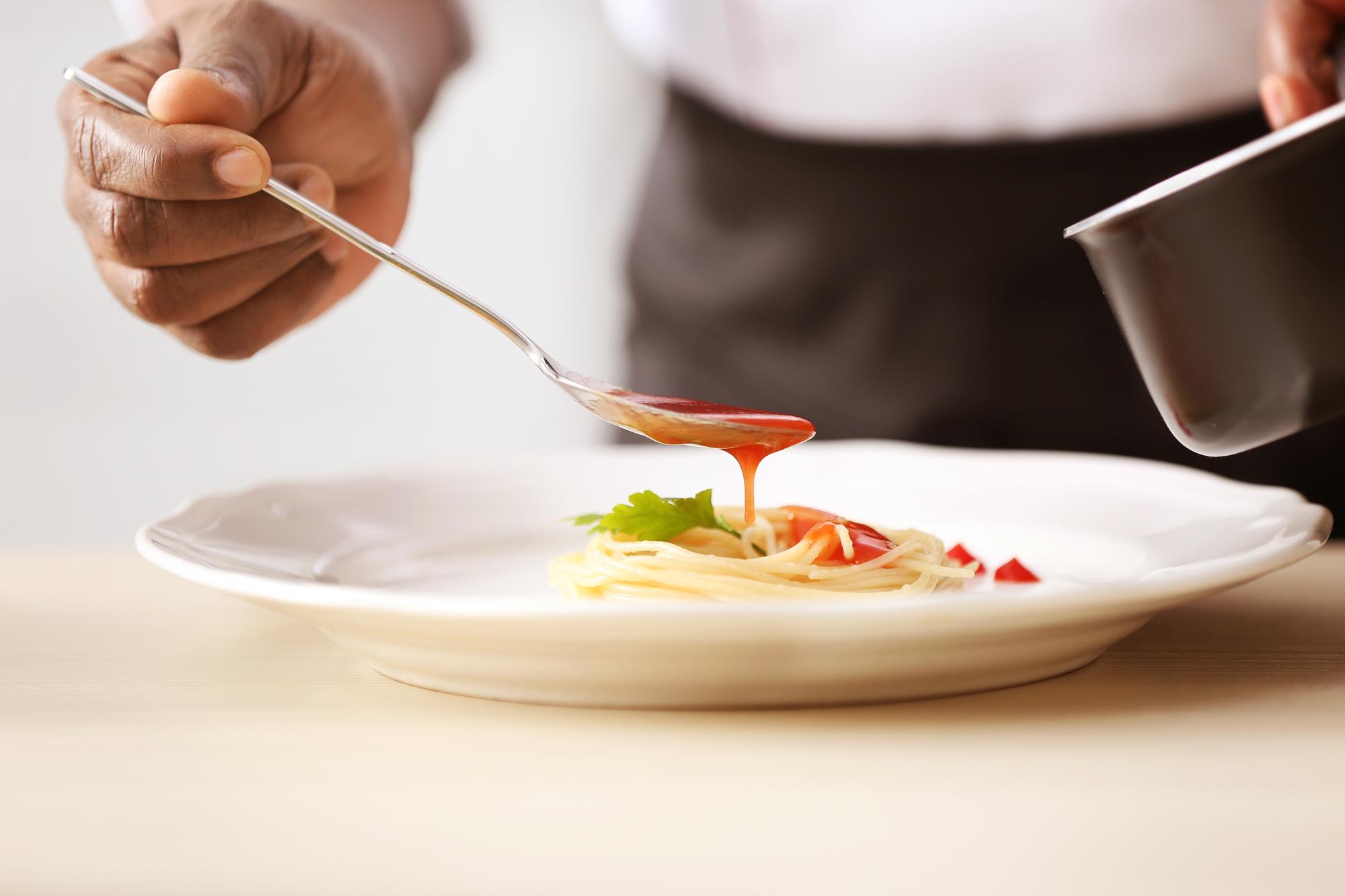 Close-up of hands finishing a plate